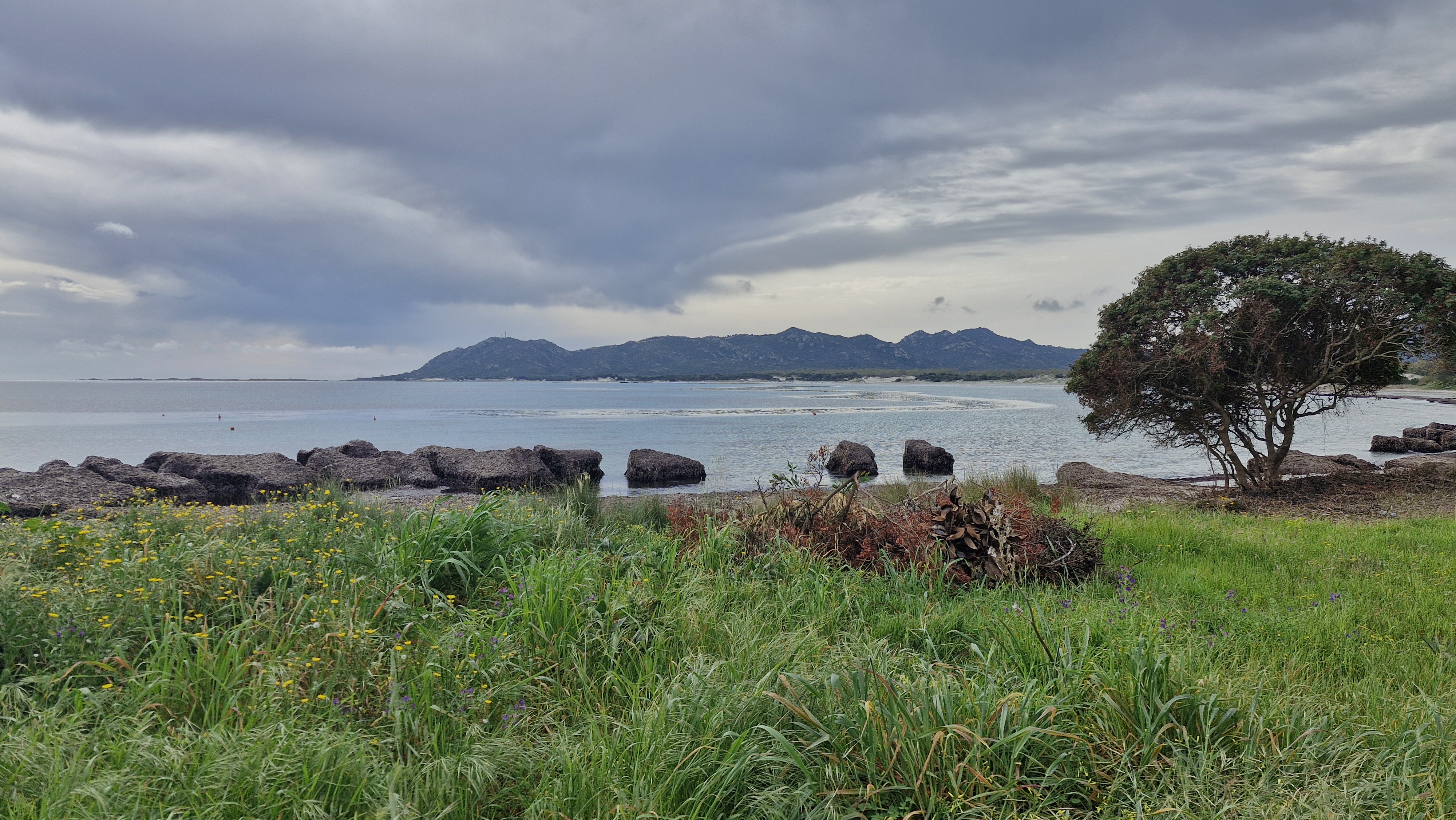 Coastal view near La Caletta under a cloudy sky.